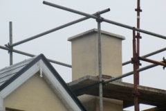 Existing chimney stack and scaffolding at roof level for safety